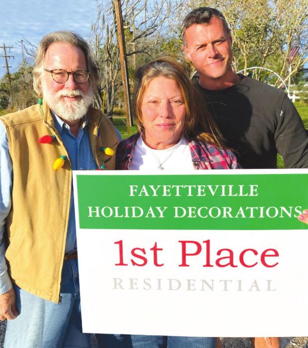 Greater Fayetteville Chamber president Jerry Herring with Christmas Decorations winners Tami and Tony Cartwright.